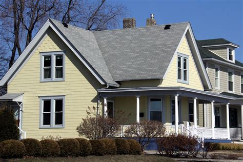 yellow house with blue metal roof|yellow house with gray roof.